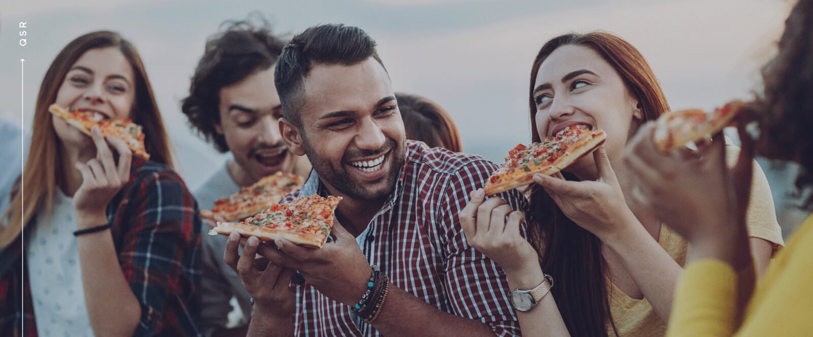 group of people eating pizza