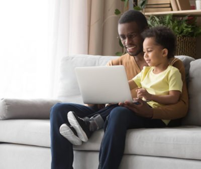 parent and child looking at laptop